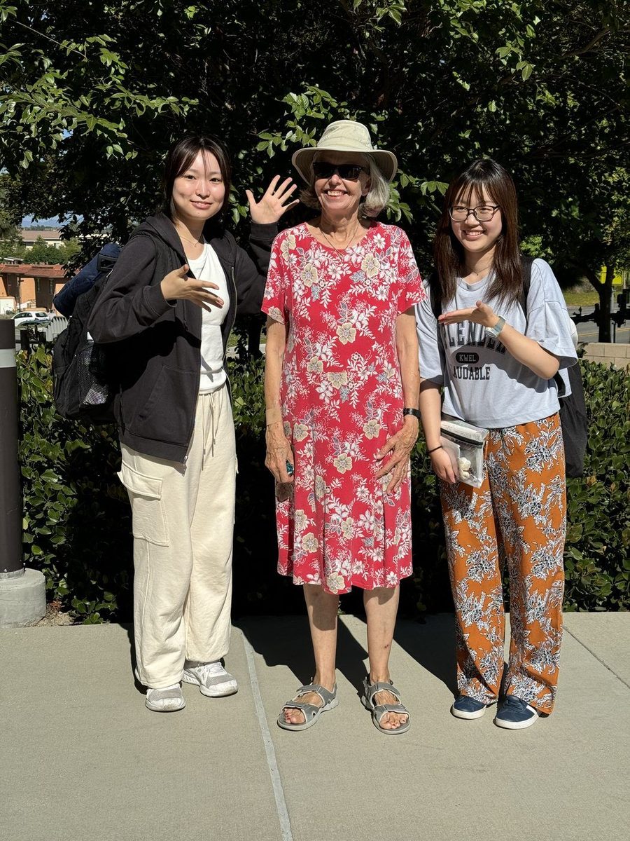 Host with two international students outdoors on a sunny day